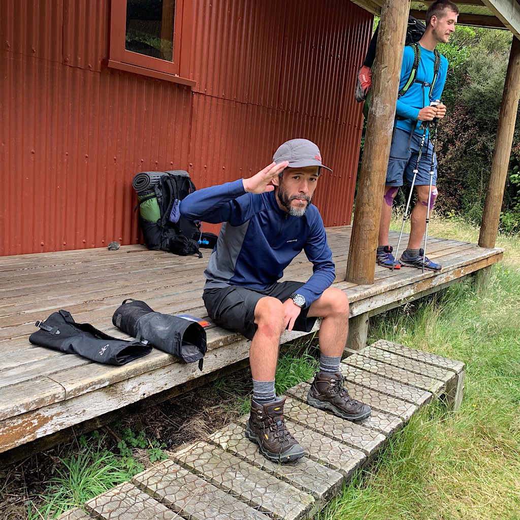 A Japanese tramper salutes me at Locke Stream Hut as Tom prepares to push on. Rain came on and off all day and the biggest crossing is ahead. 