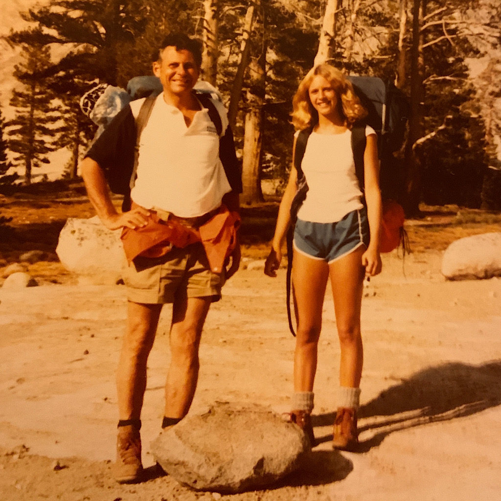 At 50 and 15, dad and I backpacked in Yosemite National Park, but why are we standing behind a rock, I wonder?
