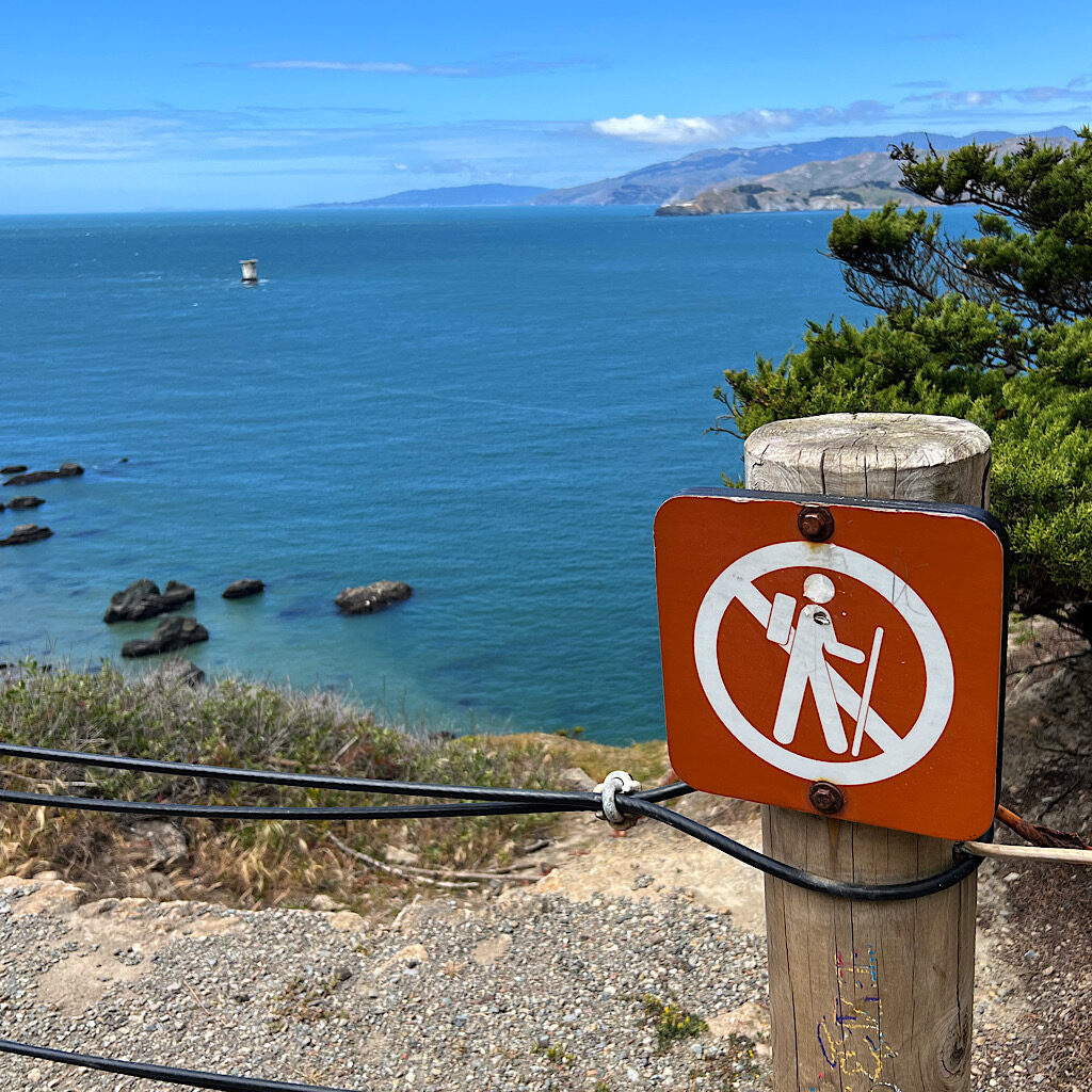 A sign warns me not to walk off the cliff. 
